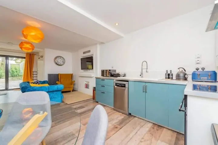 Fully equipped kitchen with teal cabinets