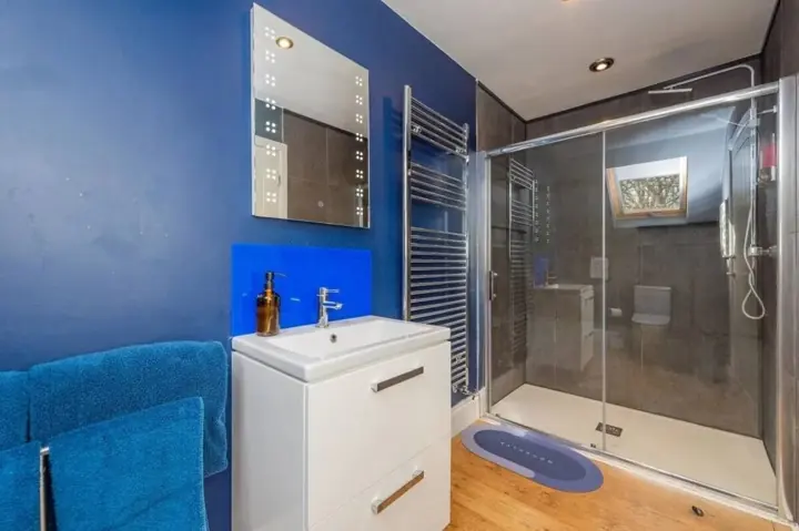 Modern shower room with walk-in shower and heated towel rail